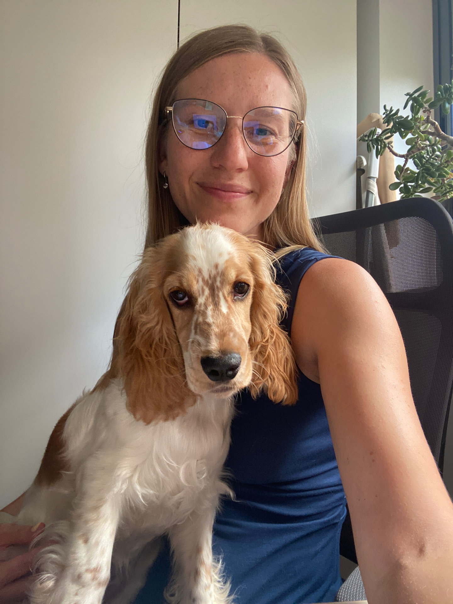 Maryna Machado at her desk with her dog